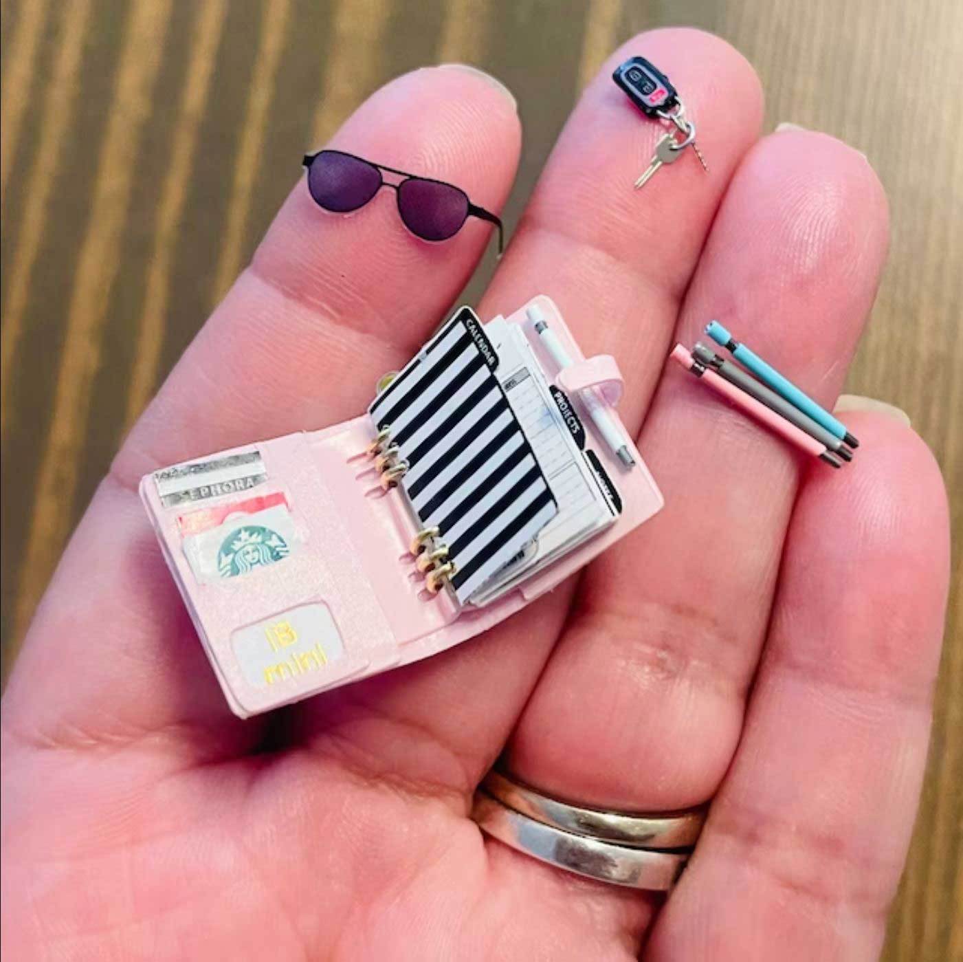 dollhouse miniature planner held in hand
