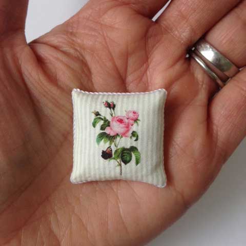 rose dollhouse pillow in hand